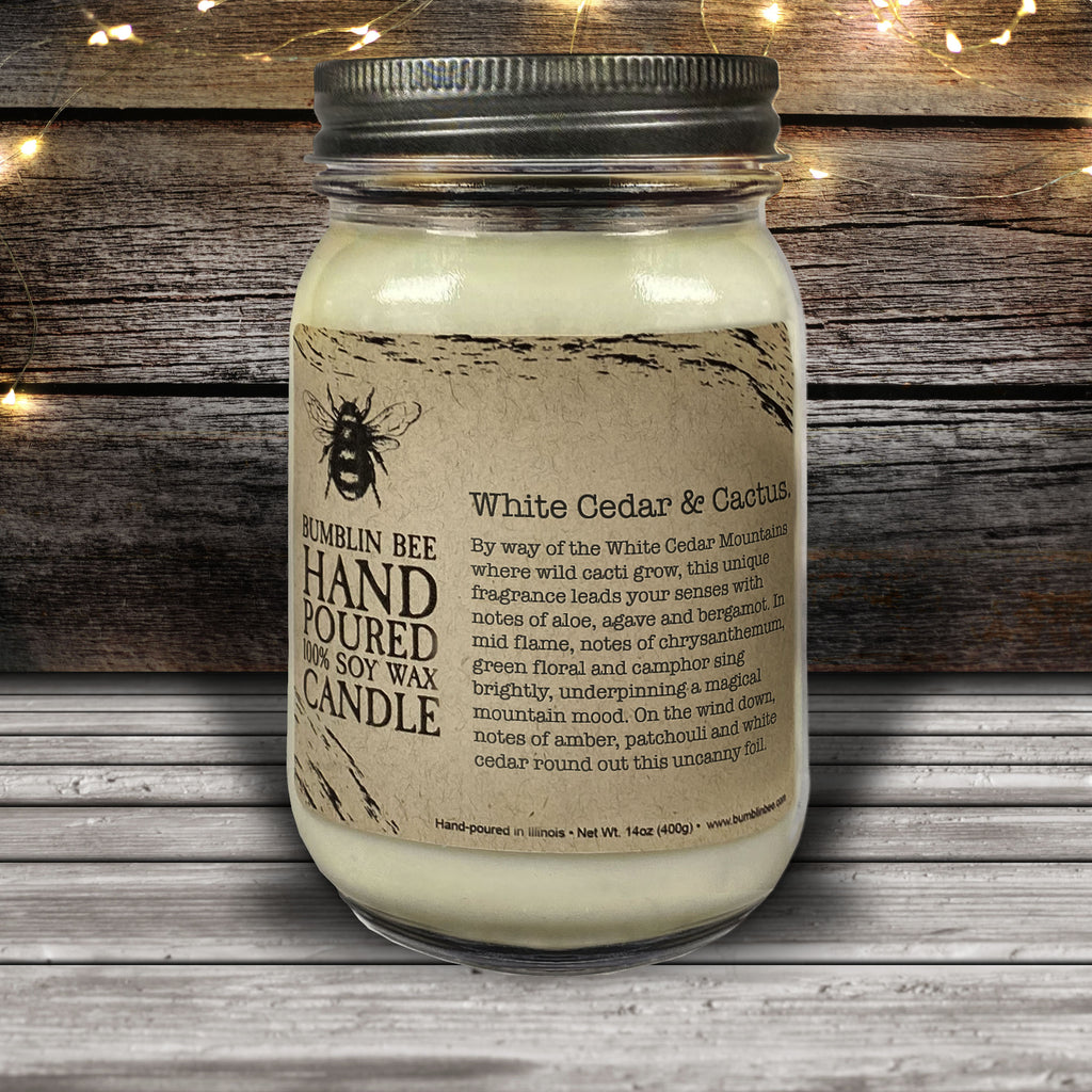 Hand poured soy wax candle in a mason jar with a wooden background