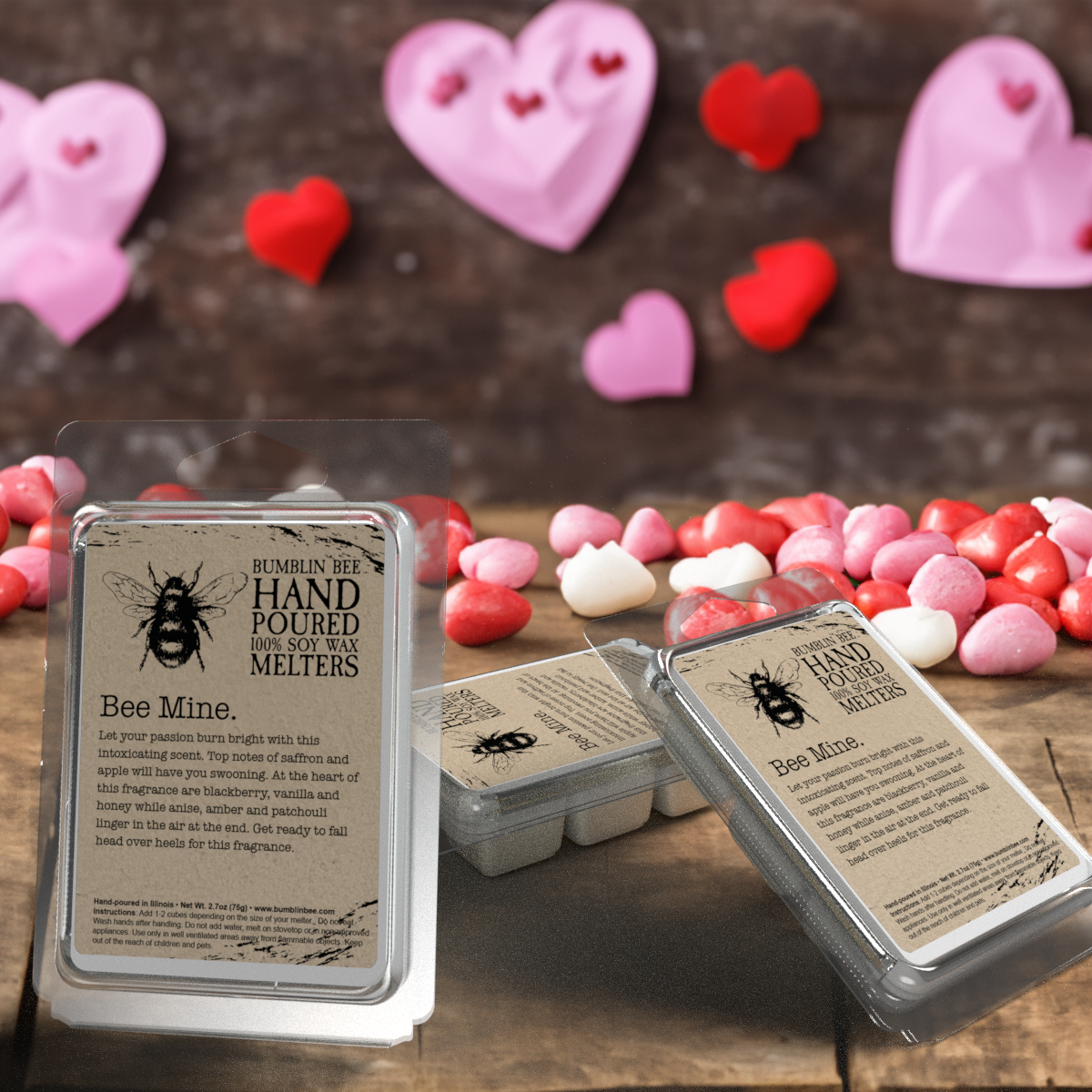 Hand poured Bumblin Bee wax melters on a wooden surface with heart-shaped decorations in the background.