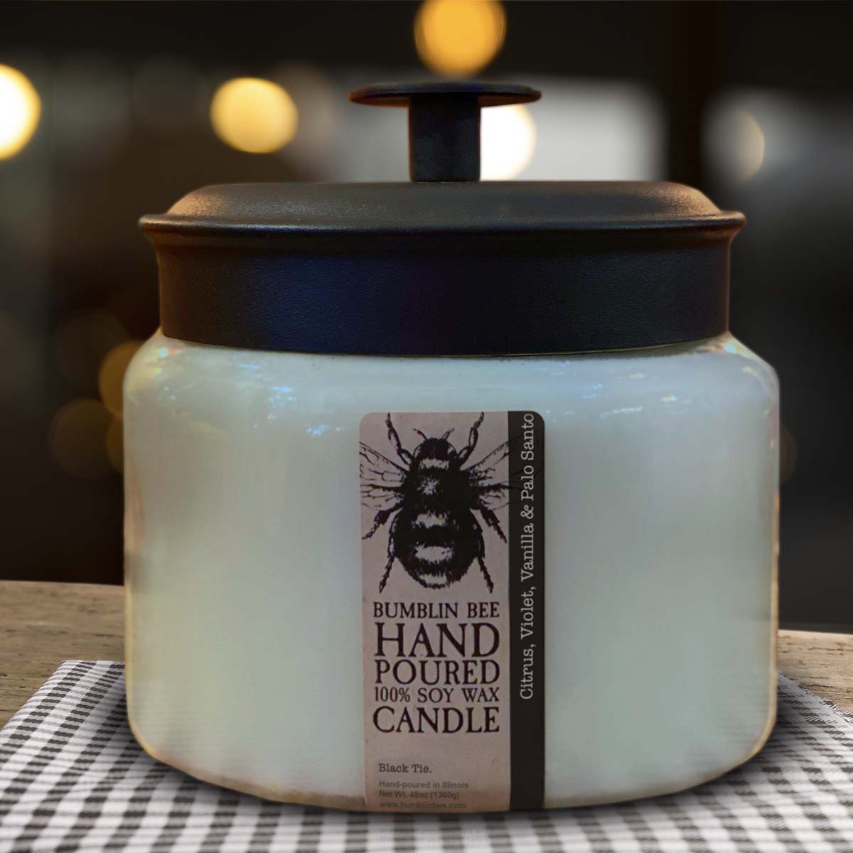 Hand poured Bumblin Bee 48oz soy wax triple wick candle on a checkered tablecloth