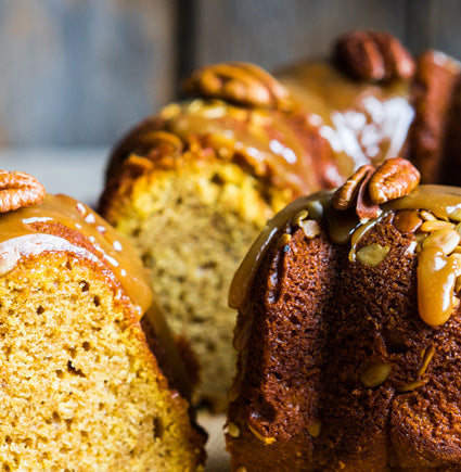Close-up of a bundt cake with caramel and pecan topping